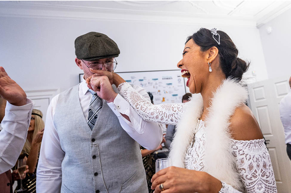 Yorkshire based Photographer Wedding image of groom kissing brides hand.